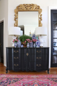 Grandmillennial Design elements such as blue and white florals,antique furniture, and decorative vases