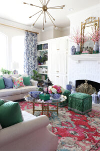 Grandmillennial design elements of color, patterns, antique furniture, pottery, and rug.