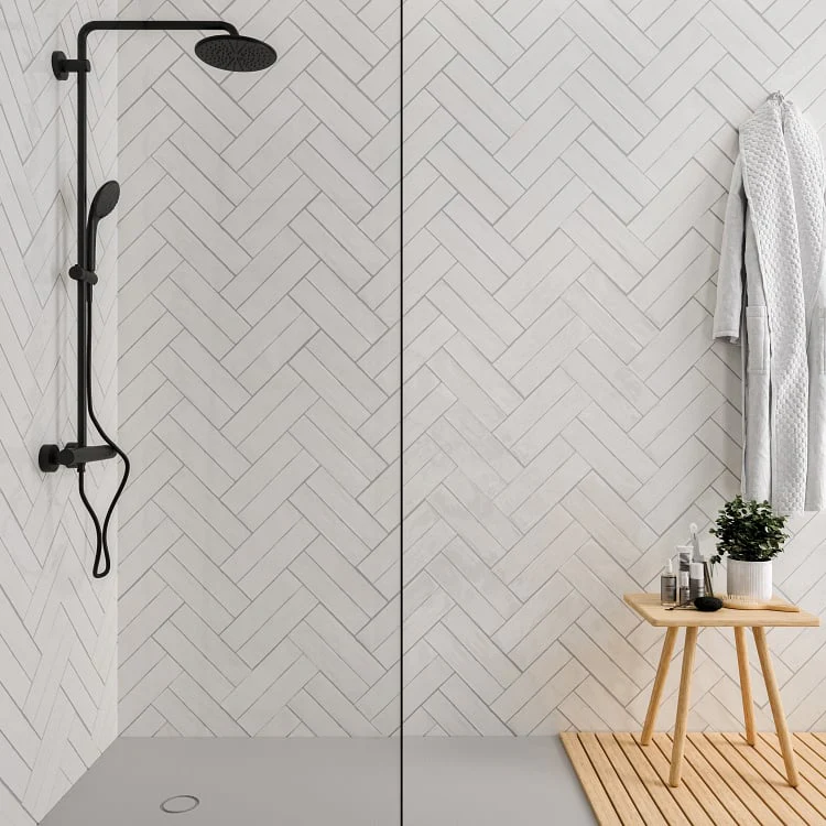 Walk-in shower with white herringbone wall tile and black shower fixture